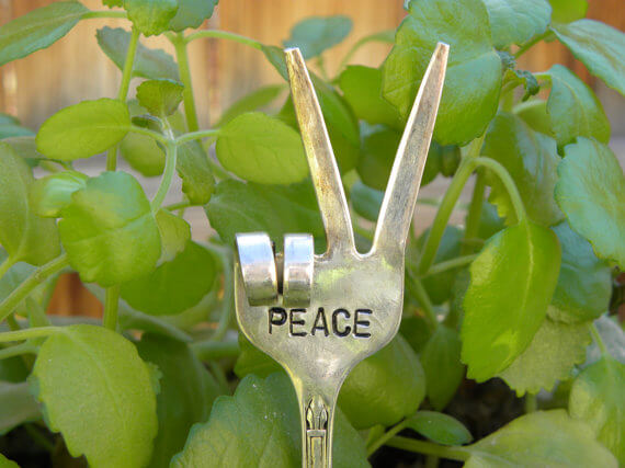 fork garden pick with the word peace