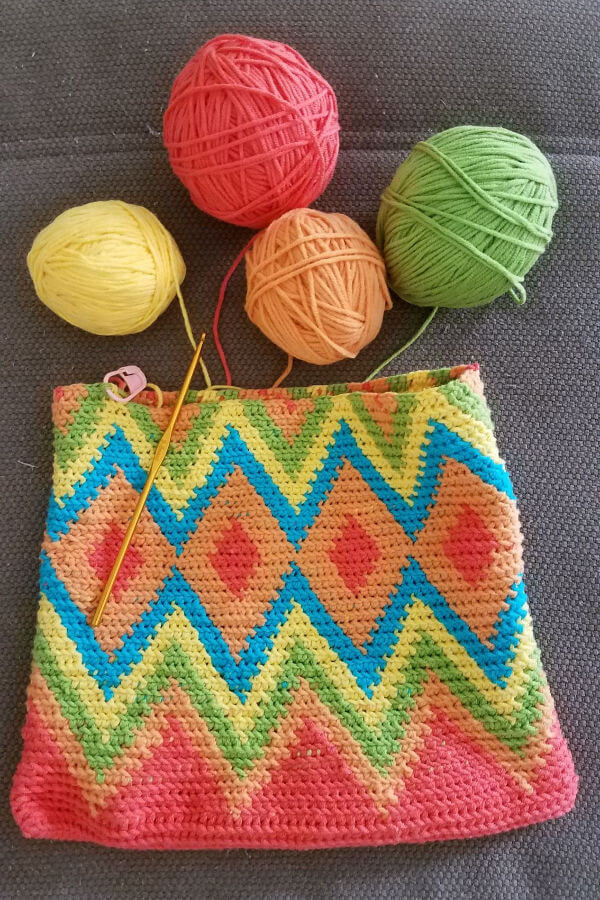 unfinished tapestry crochet cosmetic bag in multiple colors with yarn