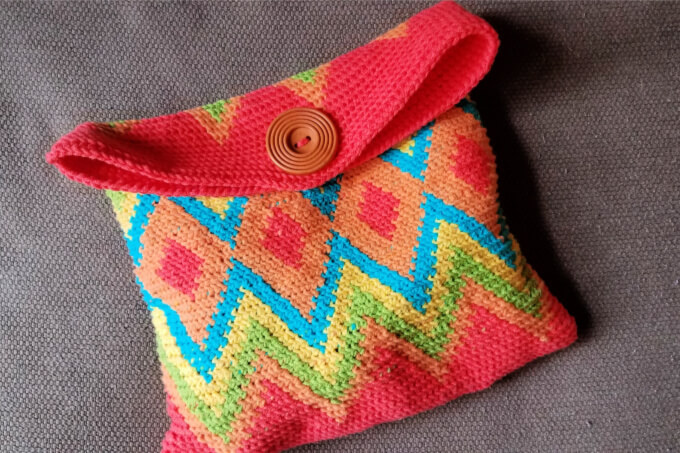 tapestry crochet bag closed with a large wooden button