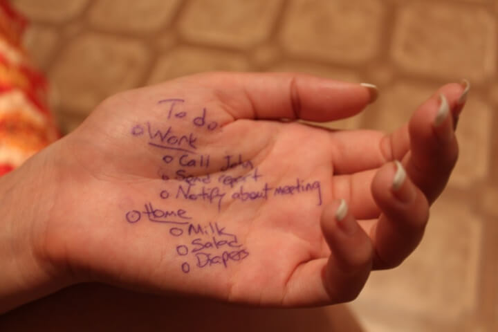 photo of a woman's hand with a to do list written on it