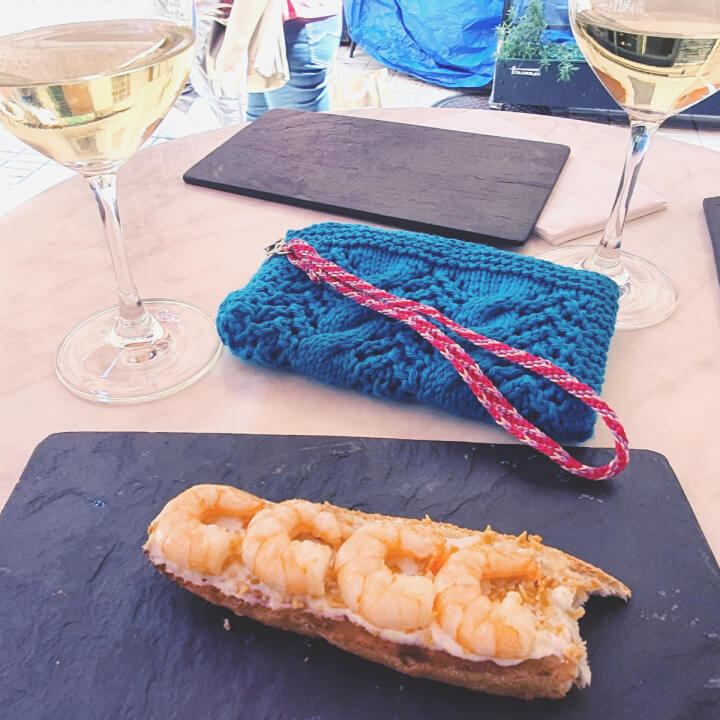 photo of a knit clutch on a table with food