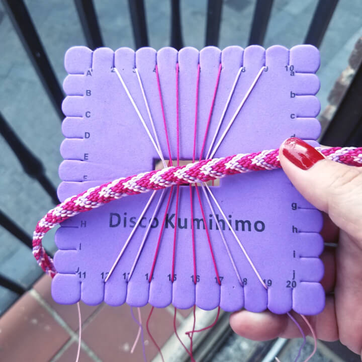 photo of the set up for a kumihimo strap to go on a knit clutch