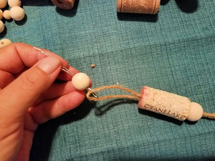 threading a bead onto the string